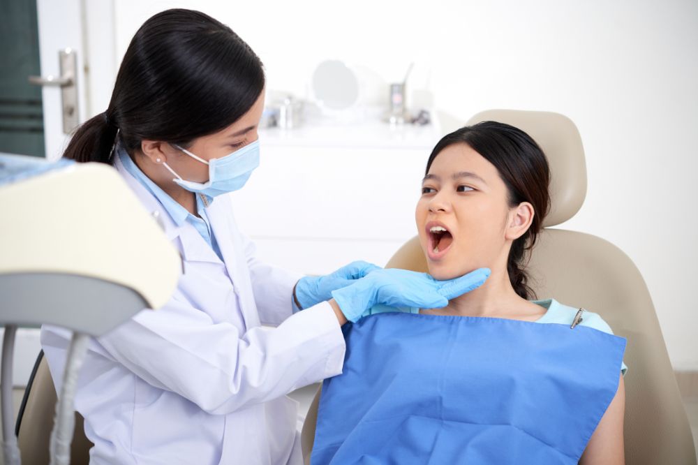 a woman is getting dental treatment