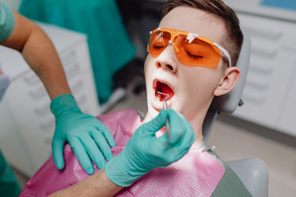 a woman is getting dental treatment.