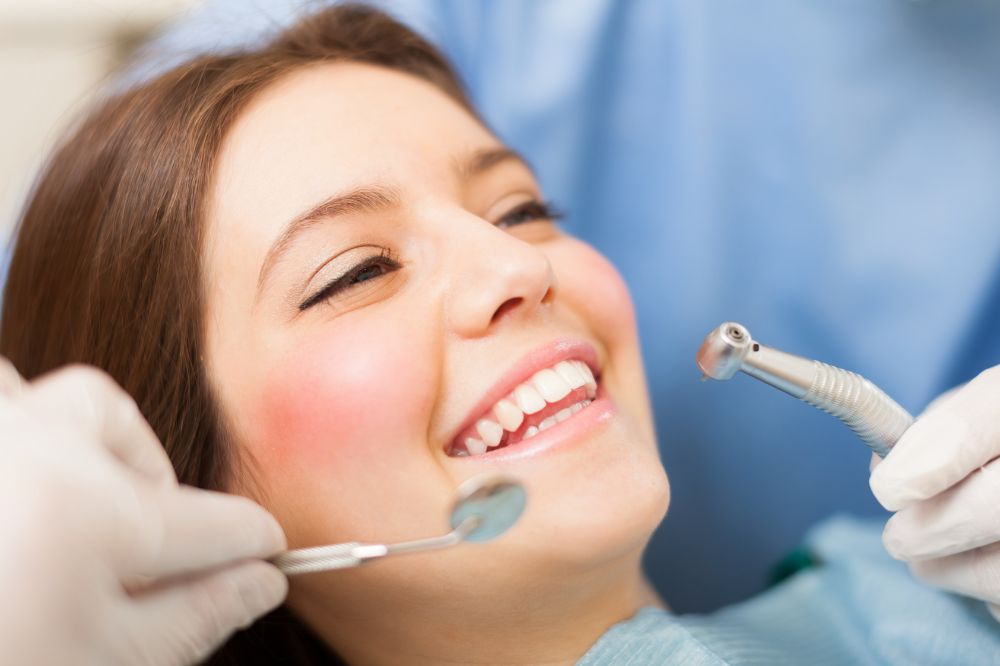 a woman is getting dental treatment.